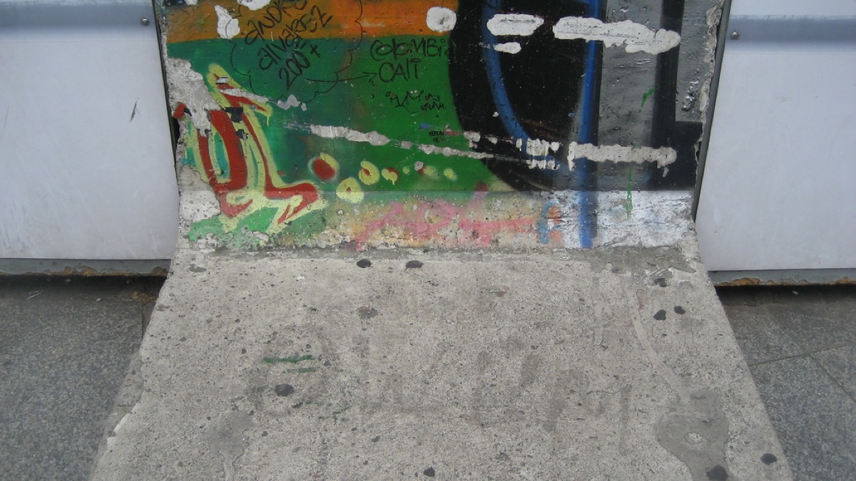 berlin wall fragments in rubble field