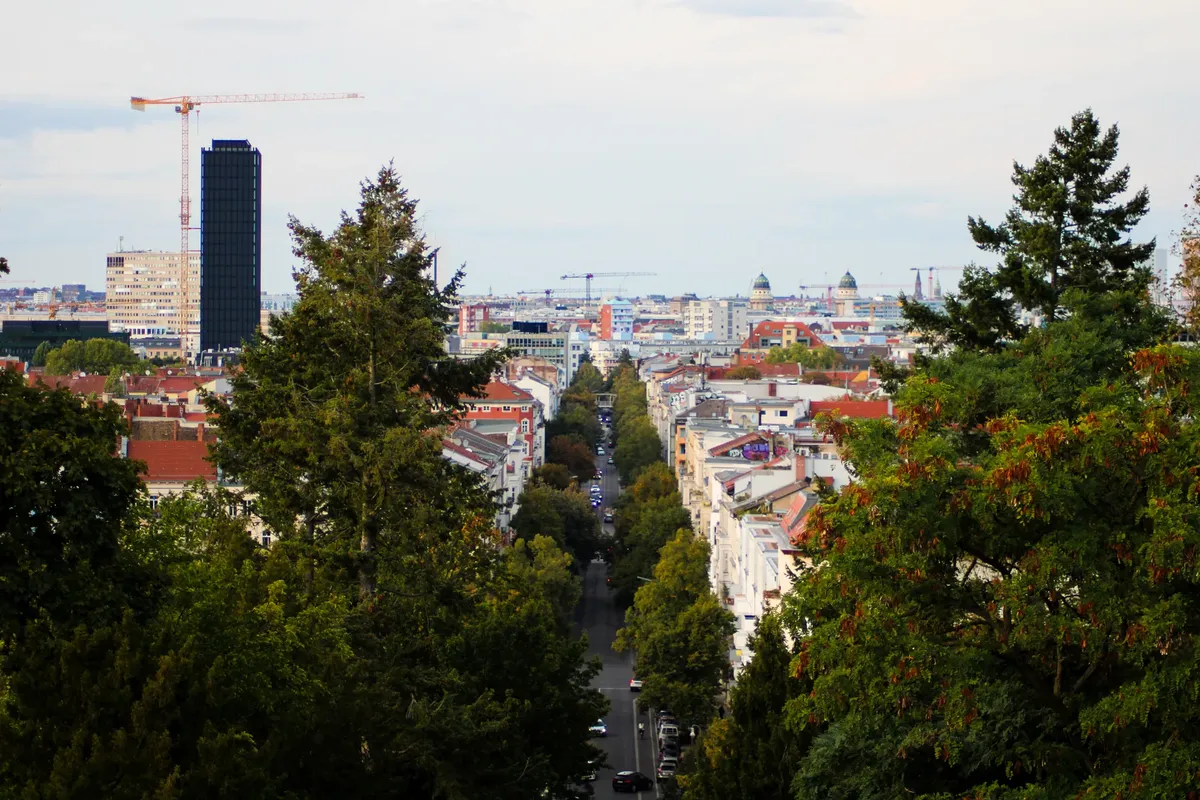 Urban view of Berlin, Germany, featuring a mix of modern and classic architecture with lush greenery.