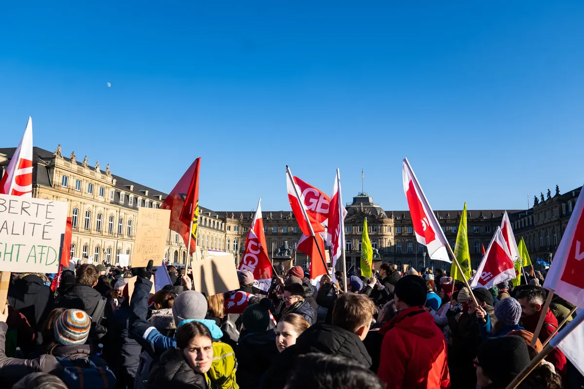 Demonstrators rally in Stuttgart against a political movement, capturing a diverse crowd and urban backdrop.