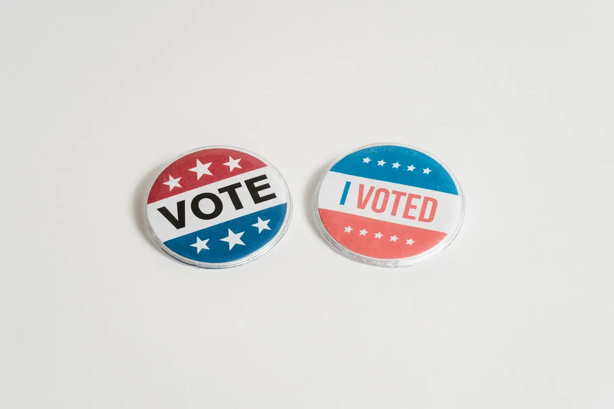 Red, white, and blue political buttons with 'Vote' and 'I Voted' text for election and civic engagement themes.